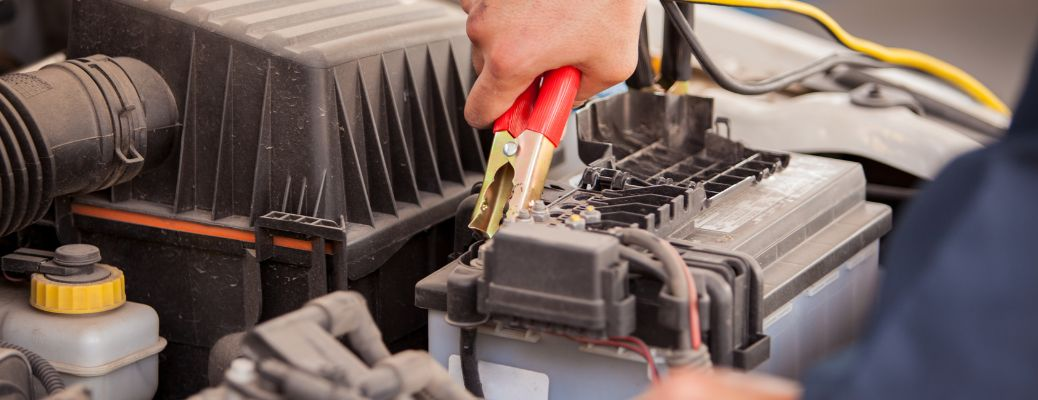 a hand jump starting a battery