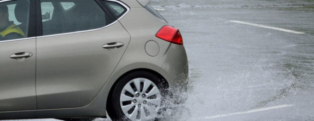 rear tire of a car on wet road
