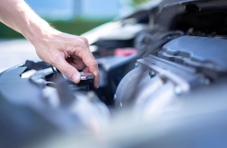 Tightening the radiator cap after checking the coolant level