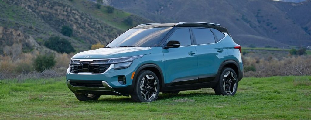 2024 Kia Seltos Parked Off-Road on a Grassy Field Near the Hills