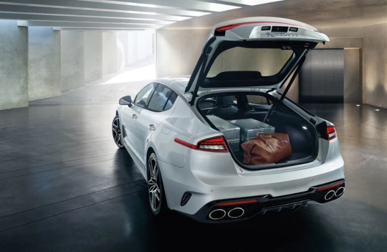 The open cargo of the 2023 Kia Stinger packed with luggage. 