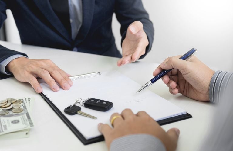 Hands of a man signing some papers