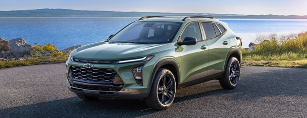 A 2020 Chevrolet Trax navigating a road with a clear blue sky in the background.