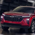 A 2020 Chevrolet Trax navigating a road with a clear blue sky in the background.