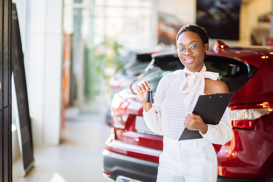 Lady examining a car inside a dealership