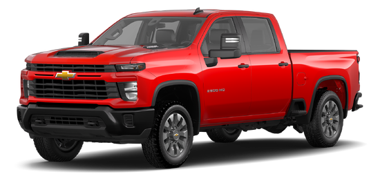 A Chevrolet Silverado 2500HD towing a large camper on a scenic road, showcasing its powerful towing capability.