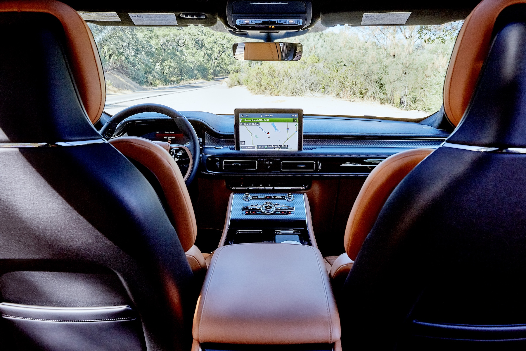Interior of a modern luxury car featuring red leather seats and dashboard.