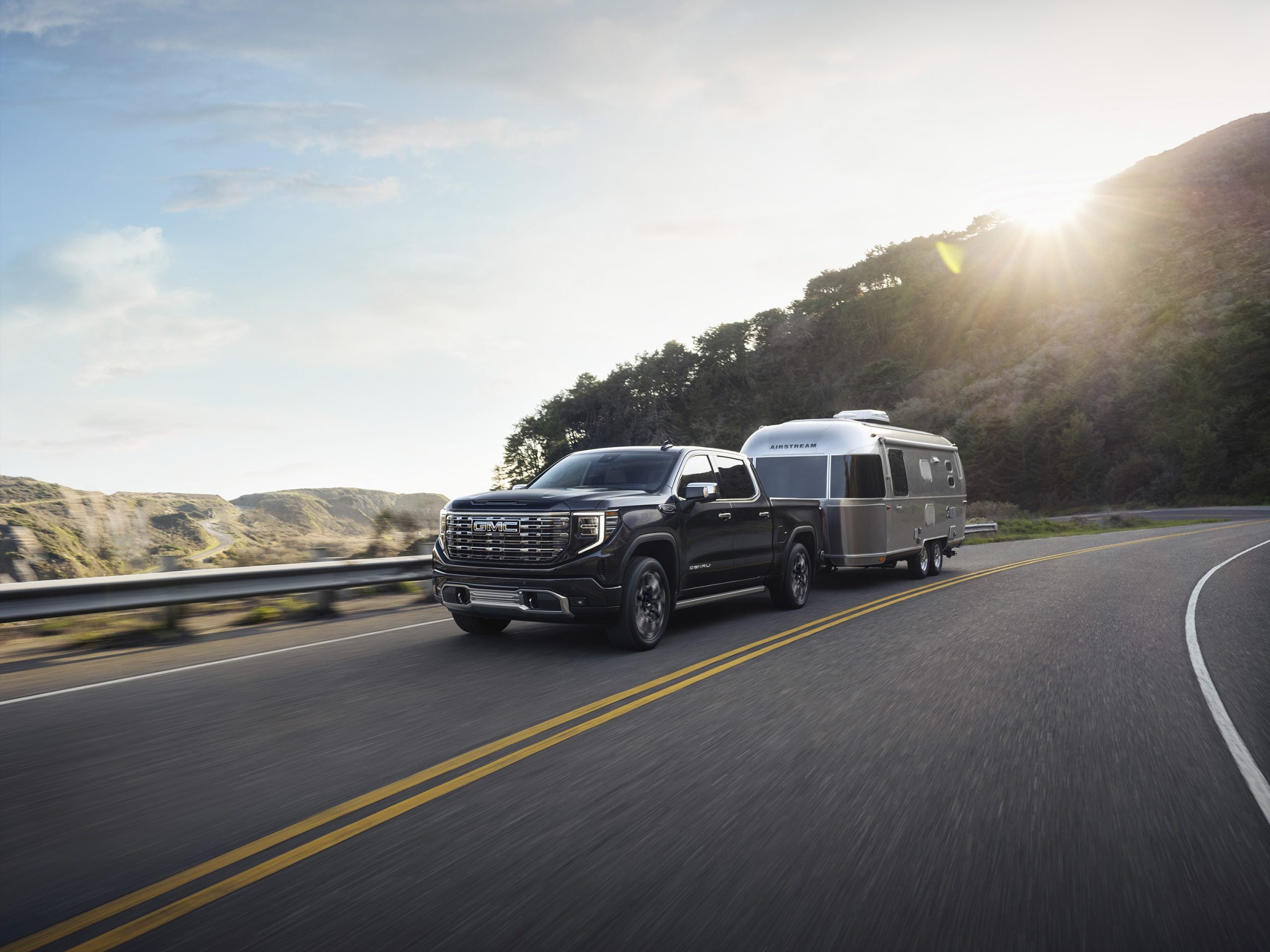 2026 GMC Sierra 1500 Denali Ultimate towing a camper