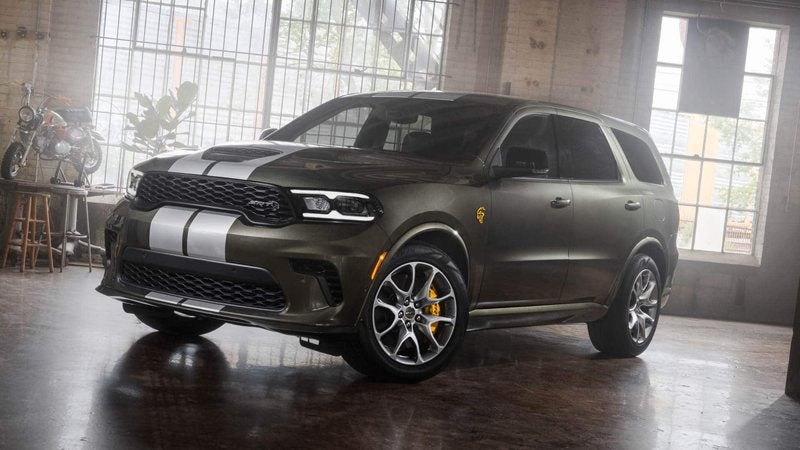 Dark green 2027 Dodge Durango SRT Hellcat with silver stripes in a brick loft; Durango financing at Ross Downing CDJR of Mobile, AL