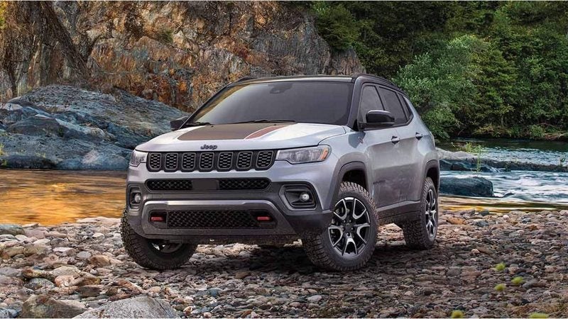 Silver 2026 Jeep Compass Trailhawk parked on river rocks; Compass financing at Ross Downing CDJR of Mobile, AL