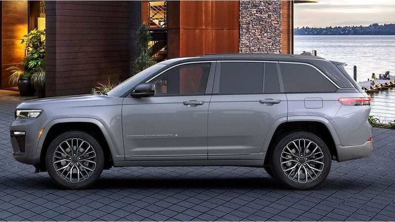 Silver 2026 Jeep Grand Cherokee in side profile outside a lakeside home; Grand Cherokee specials at Ross Downing CDJR of Mobile, AL