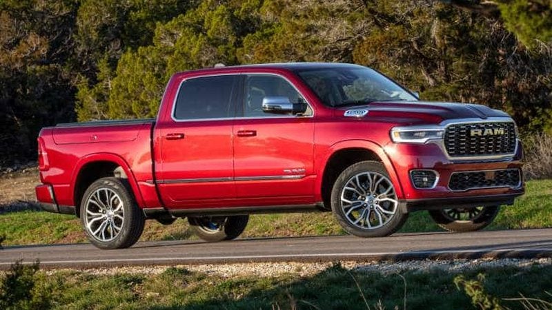 Red 2026 Ram 1500 Crew Cab on a country road; Ram 1500 financing at Ross Downing CDJR of Mobile, AL