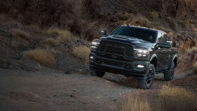 Gray 2026 Ram 2500 Crew Cab on a rocky trail at dusk; Ram 2500 financing at Ross Downing CDJR of Mobile, AL