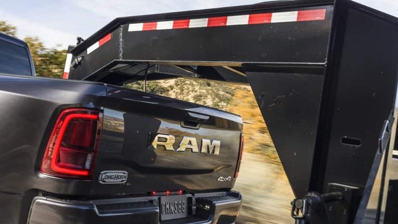 2026 Ram 3500 Limited Longhorn 4x4 hitched to a gooseneck trailer; trade in your vehicle at Ross Downing CDJR of Mobile, AL