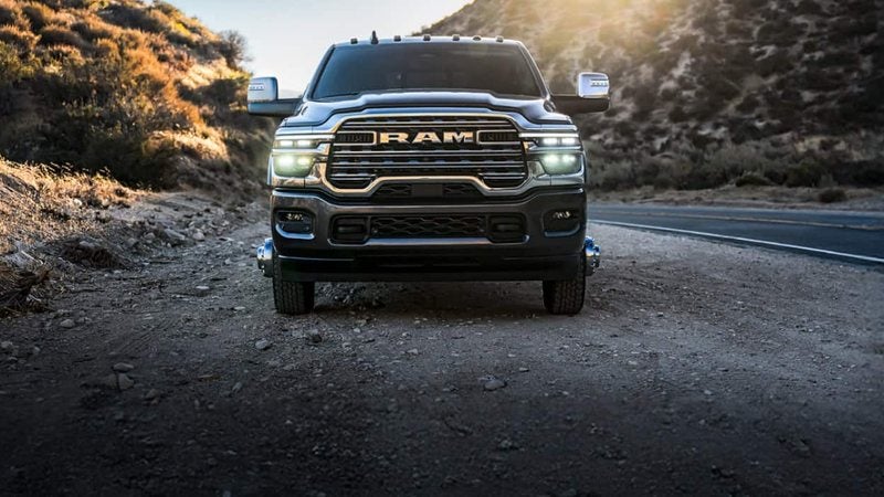 Front view of a 2026 Ram 3500 on a mountain road at sunset; Ram 3500 financing at Ross Downing CDJR of Mobile, AL
