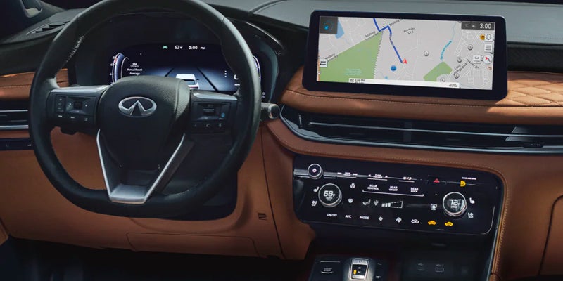The interior dashboard of a car featuring an Infiniti QX60 steering wheel, digital instrument cluster.