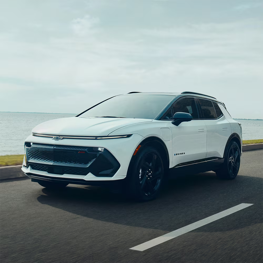 White 2026 Chevrolet Equinox EV driving on the road