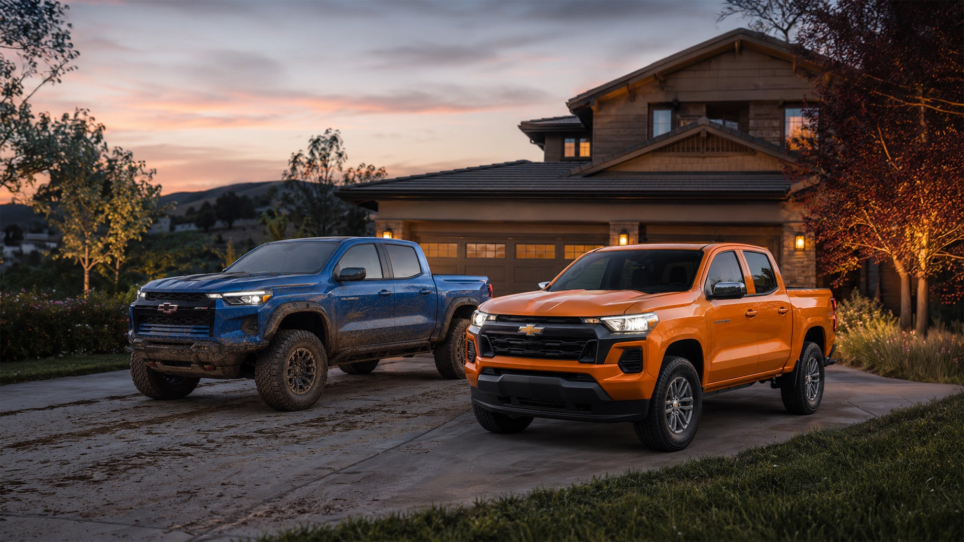 A blue and orange 2026 Chevrolet Colorado parked side by side in a residential driveway at sunset, showcasing the contrast between off‑road and daily‑driver trims available at Delta Chevrolet in Pittsburg, CA.
