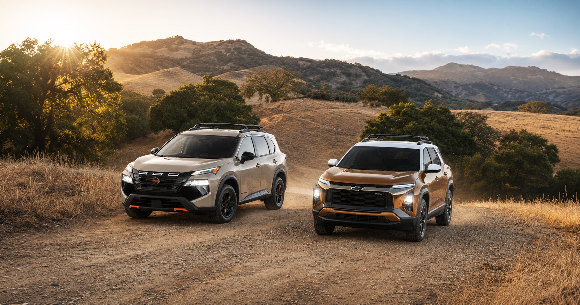 A bronze 2027 Chevrolet Equinox and a silver 2026.5 Nissan Rogue parked on a dirt trail surrounded by rolling hills and trees at sunset near Pittsburg, California, showcasing their rugged off-road capability and adventure-ready trims.