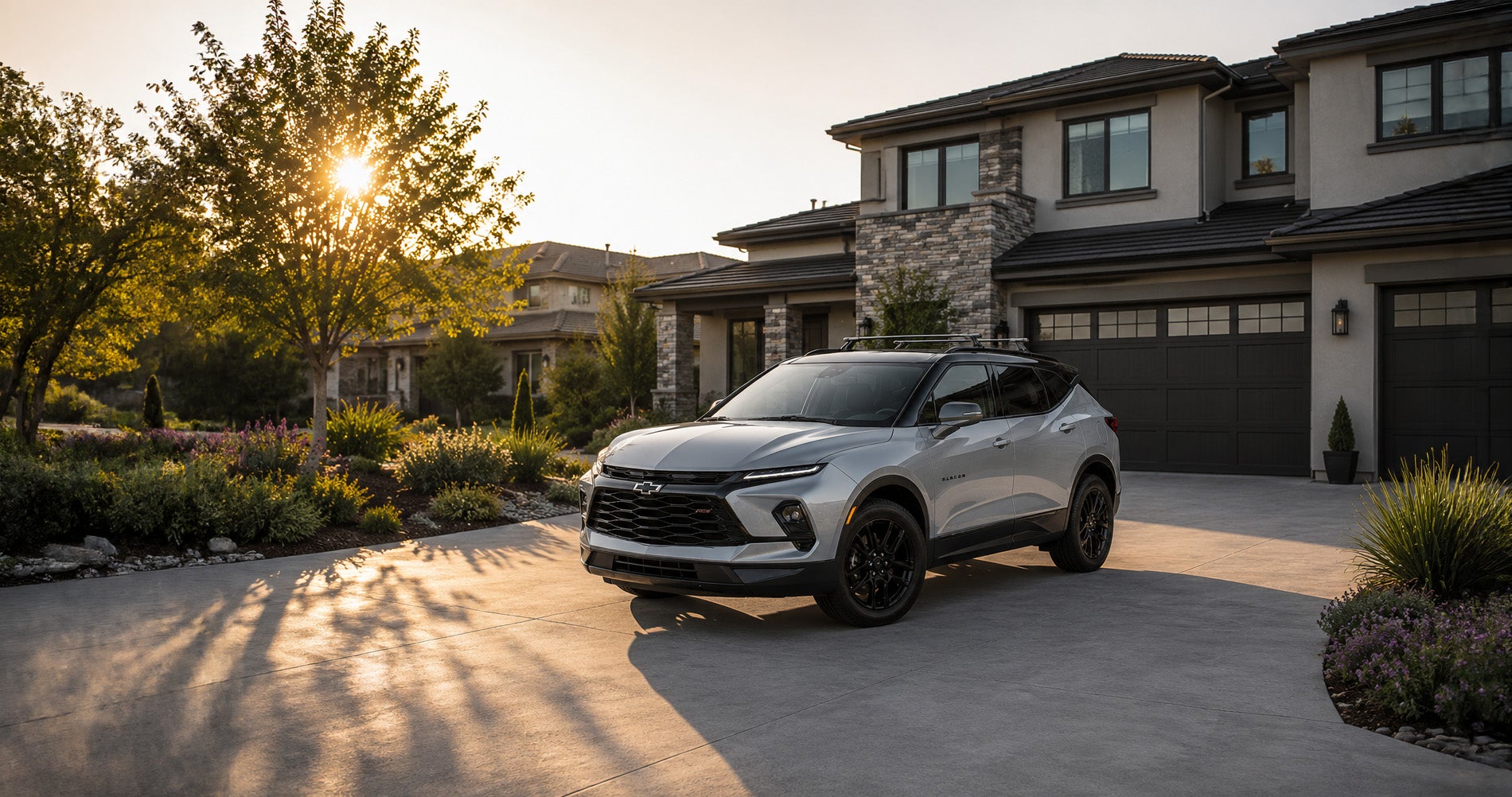 Silver Blazer RS parked in modern driveway at sunset, highlighting sleek design and upscale styling.