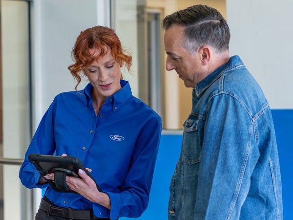 Ford Service Tech Showing Service Work Order to Customer