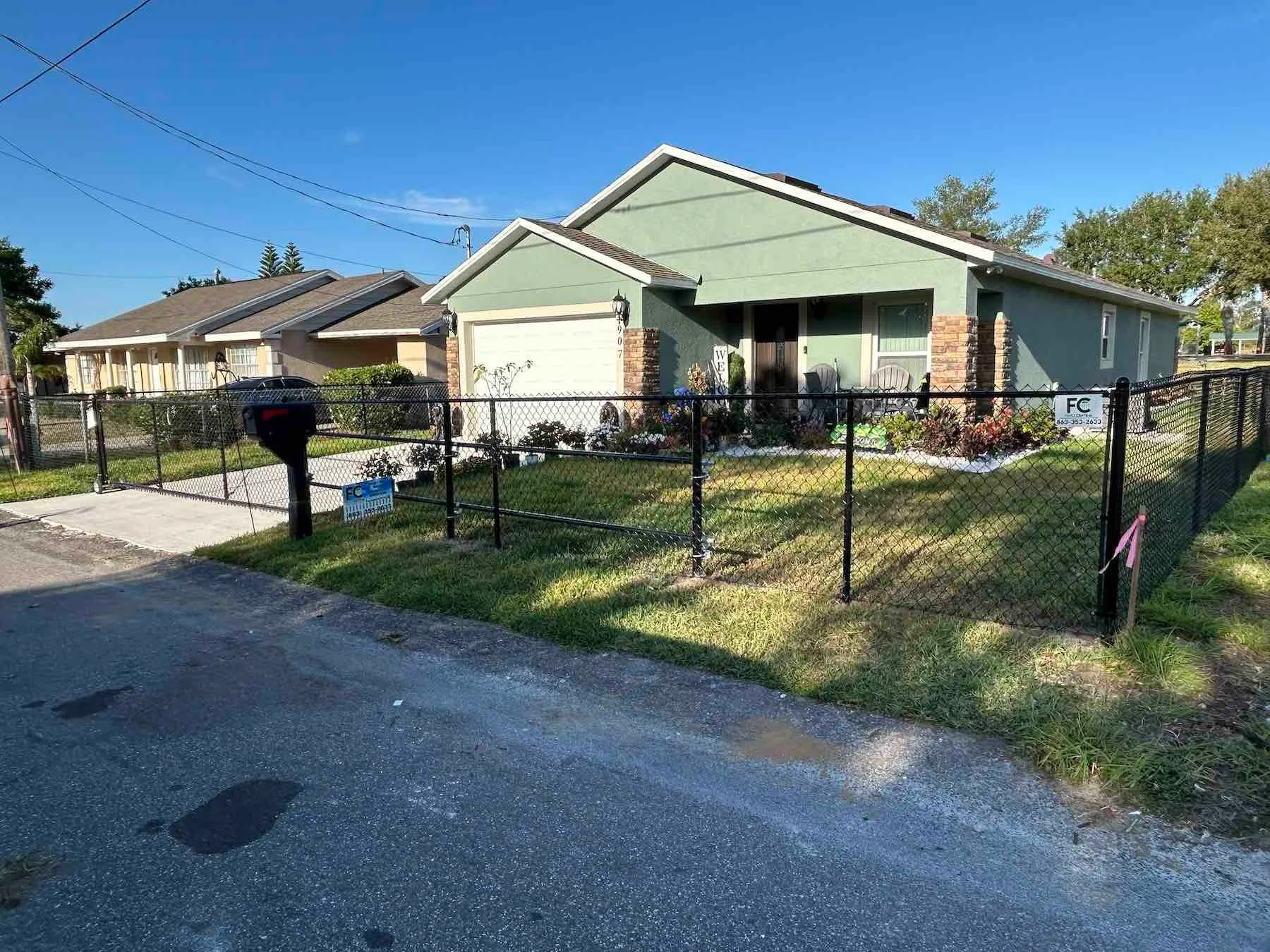 Modern chain link fence in front of a house