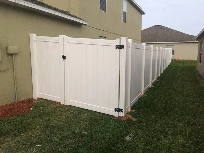 wooden vinyl fence behind a house