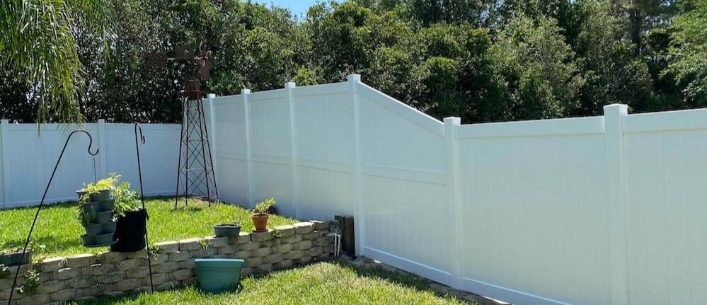 Modern vinyl fence in front of a house