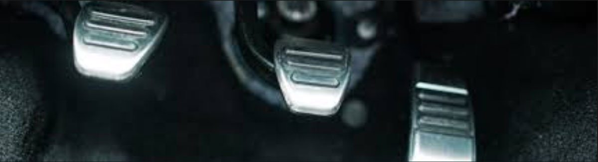 Close-up, angled view of a car's metallic gears from a disassembled transmission casing.