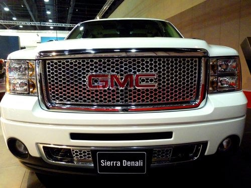 A teal GMC Sierra pickup truck.