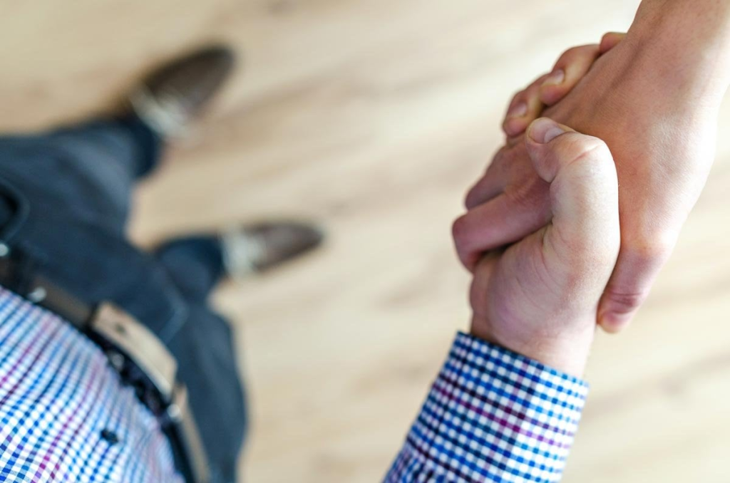 Close-up of two people shaking hands.