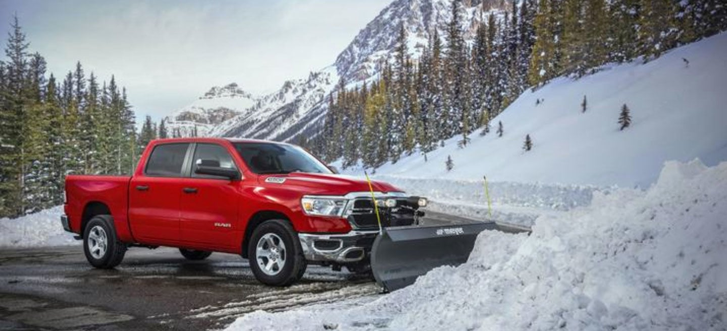 A Ram pickup truck driving through snowy conditions
