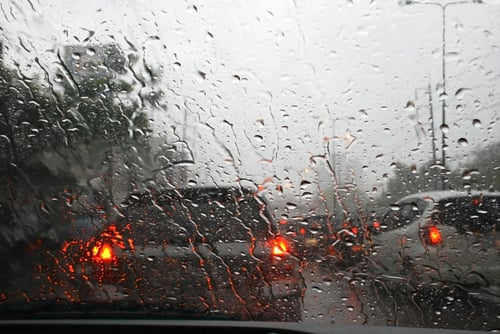 Truck driving safely in heavy rain conditions.
