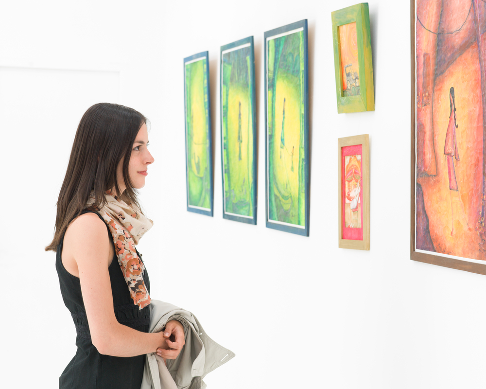People exploring museum gallery artwork displays