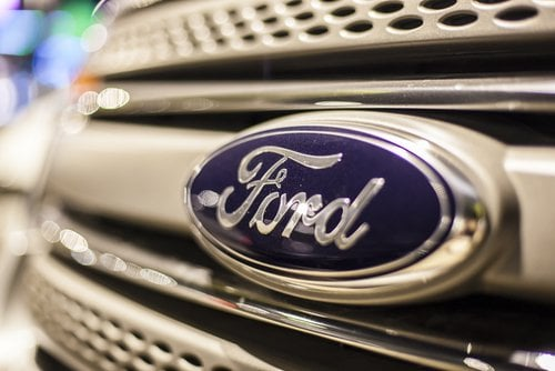Ford F‑150 driving on open road.