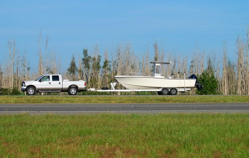 Pickup truck towing a camper trailer.

