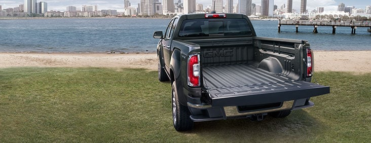 A dark blue GMC Canyon Denali truck.