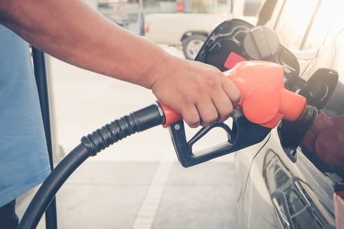 Engine oil being poured into a car engine.