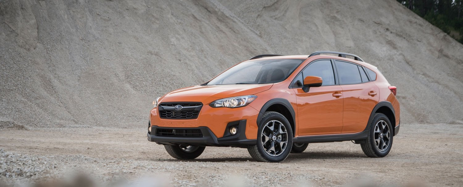 Subaru Crosstrek driving on a forest dirt trail.