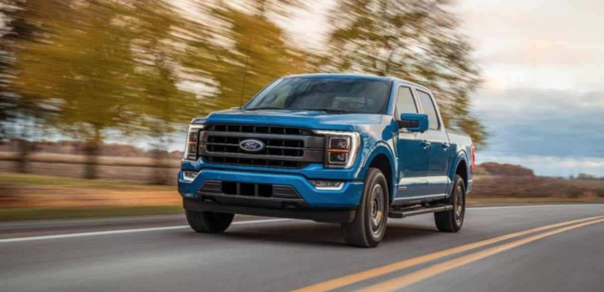 Ford pickup truck driving on a winding mountain road