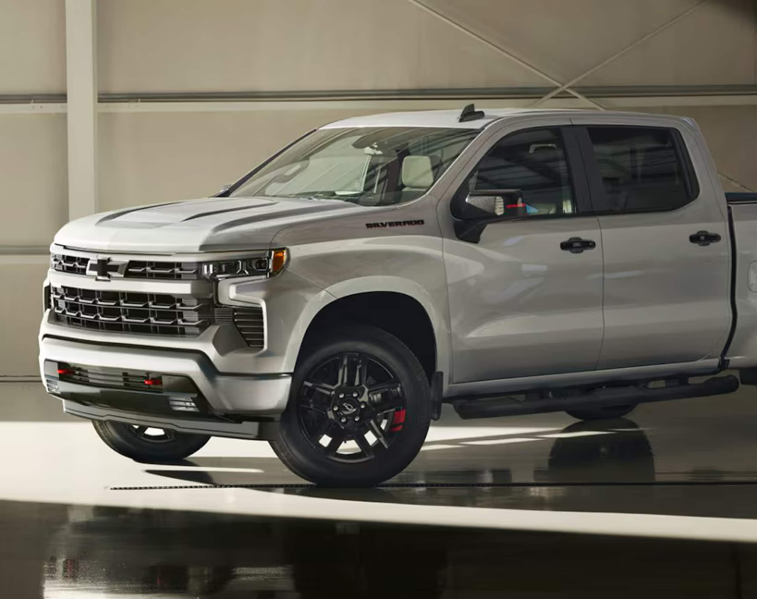 A white Chevrolet Silverado pickup is parked.