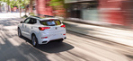 White Buick Encore GX is running on the road.