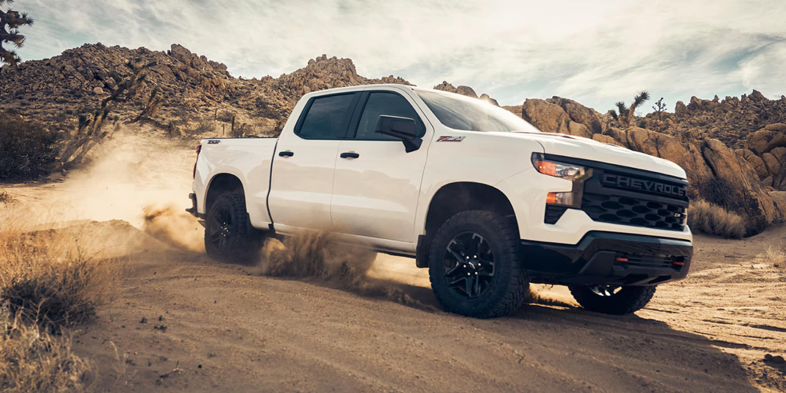 2025 Silverado 1500 is parked in the dirty mountain region.