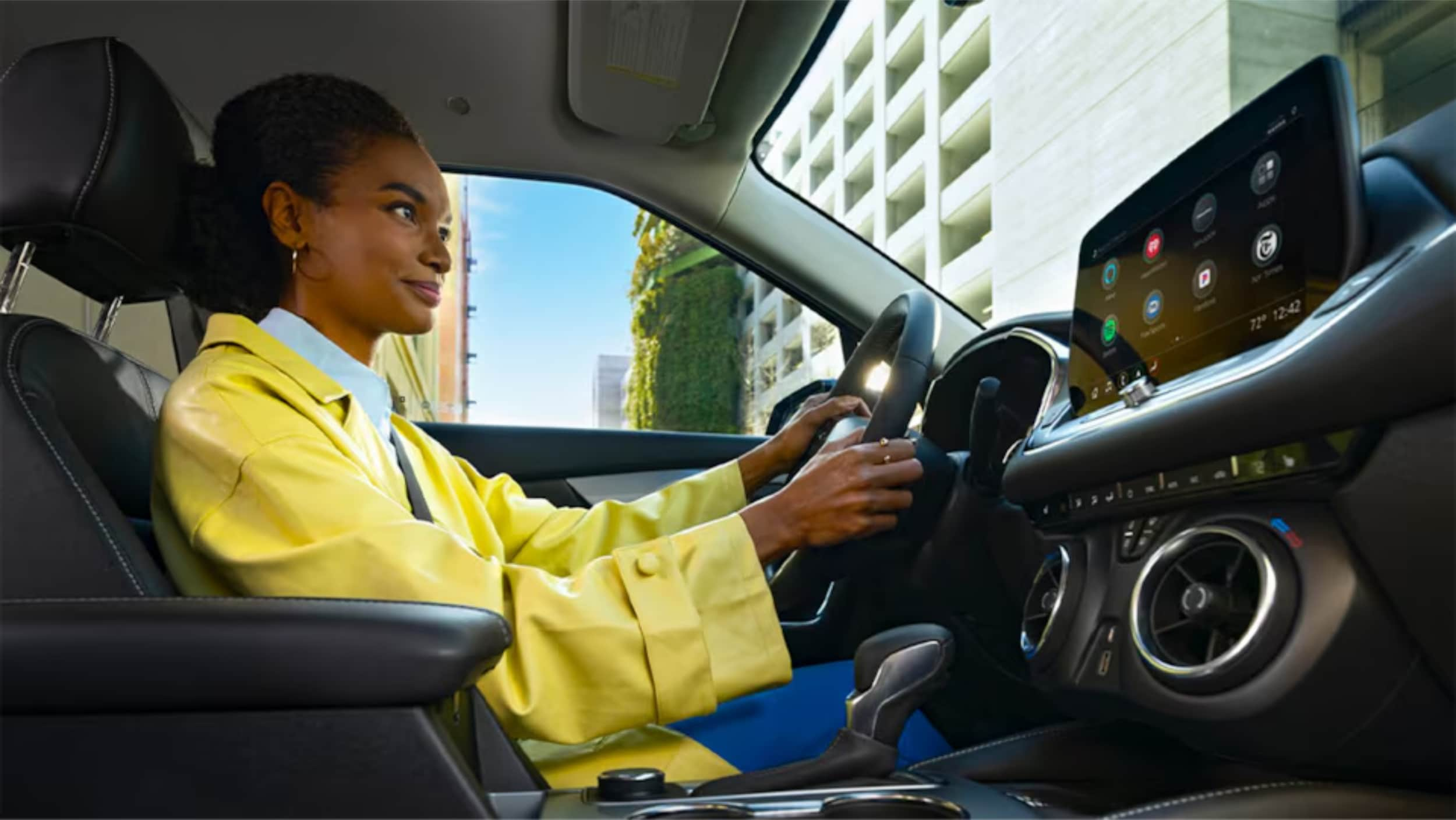 A Women is sitting on driving seat.