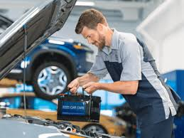  Hyundai technician testing car battery at McCarthy Hyundai of Lawrence KS service center 
