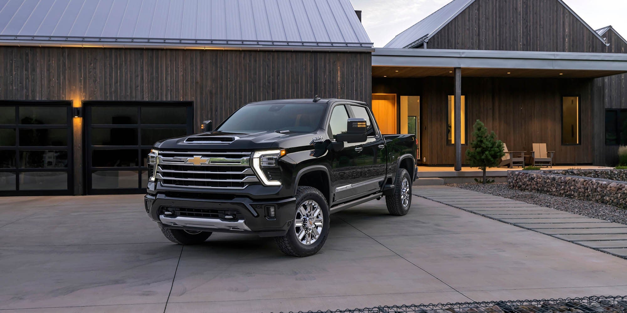 Black 2026 Chevy Silverado 2500 HD parked on a driveway.
