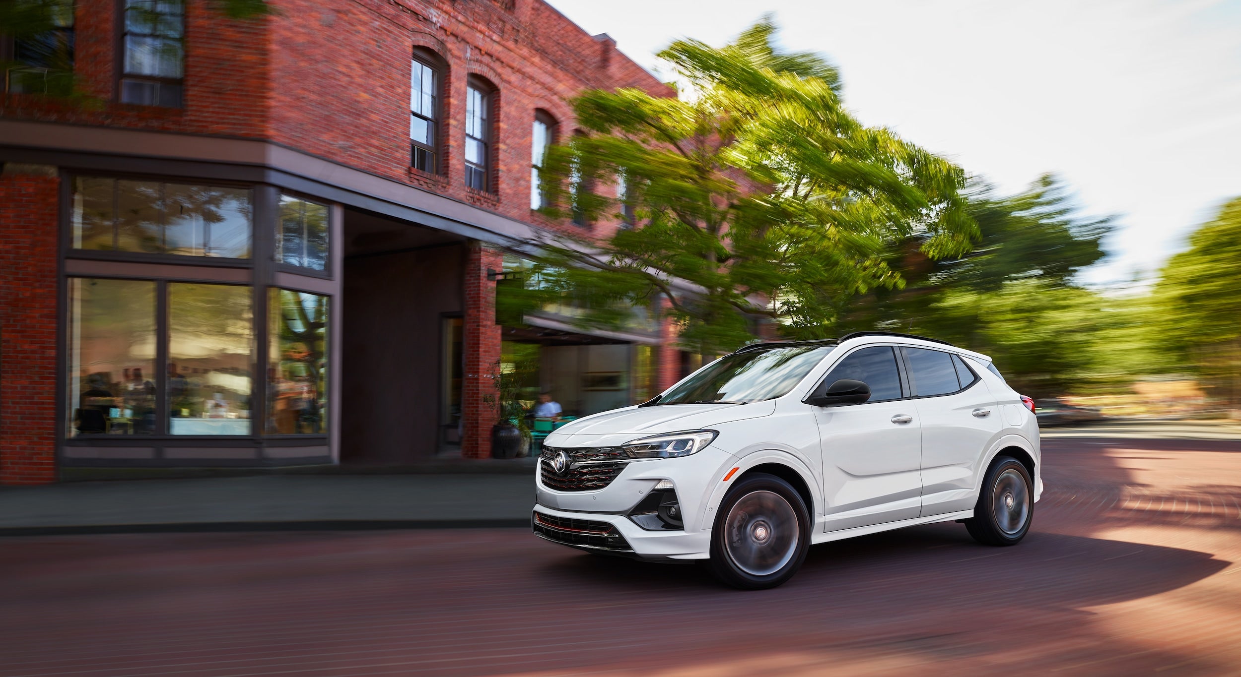 Buick Encore GX driving on road.