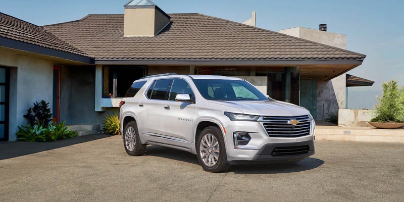 2022 Chevrolet Traverse parked outside house.