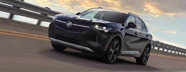 Buick Envision Avenir driving on road.
