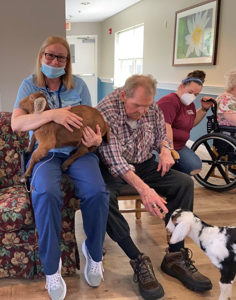 Residents and staff with baby goats